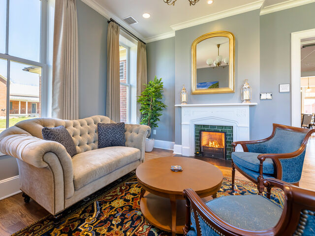 The Grayson Parlor at The Inn at Foster Falls — sofa and chairs opening toward a banquet room