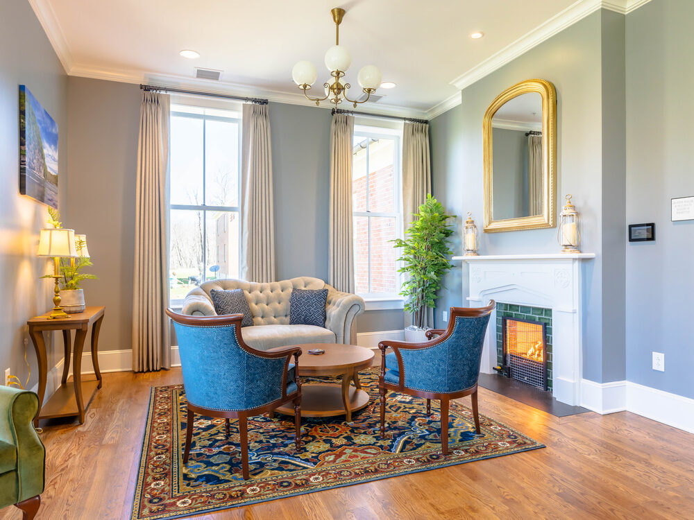 The Grayson Parlor at The Inn at Foster Falls — a sitting room with a fireplace, settee and armchairs